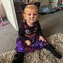 Hope joined the competition — help win amazing prizes! toddler, child, costume, cat_ears, face_paint, purple_skirt, black_tights, indoor, carpet, rug, smiling, sitting, cute, playful, toy_stroller, pet_crate, curious, blond_hair, blue_eyes, floor