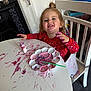 Hope joined the competition — help win amazing prizes! toddler, child, smiling, paint, messy, table, red_clothing, face_paint, indoor, chair, highchair, art_supplies, paintbrush, play, happy, expression, hair_tied, white_table, purple_paint, creative