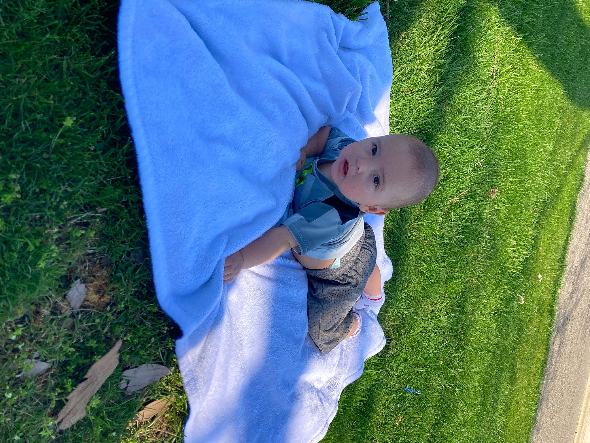 Jake is registered to the contest to win money with this photo: azure, baby, baby_toddler_clothing, child, electric_blue, fun, gesture, grass, grass_family, grassland, happy, hat, lawn, leaf, leisure, natural_environment, people_in_nature, person, plant, product