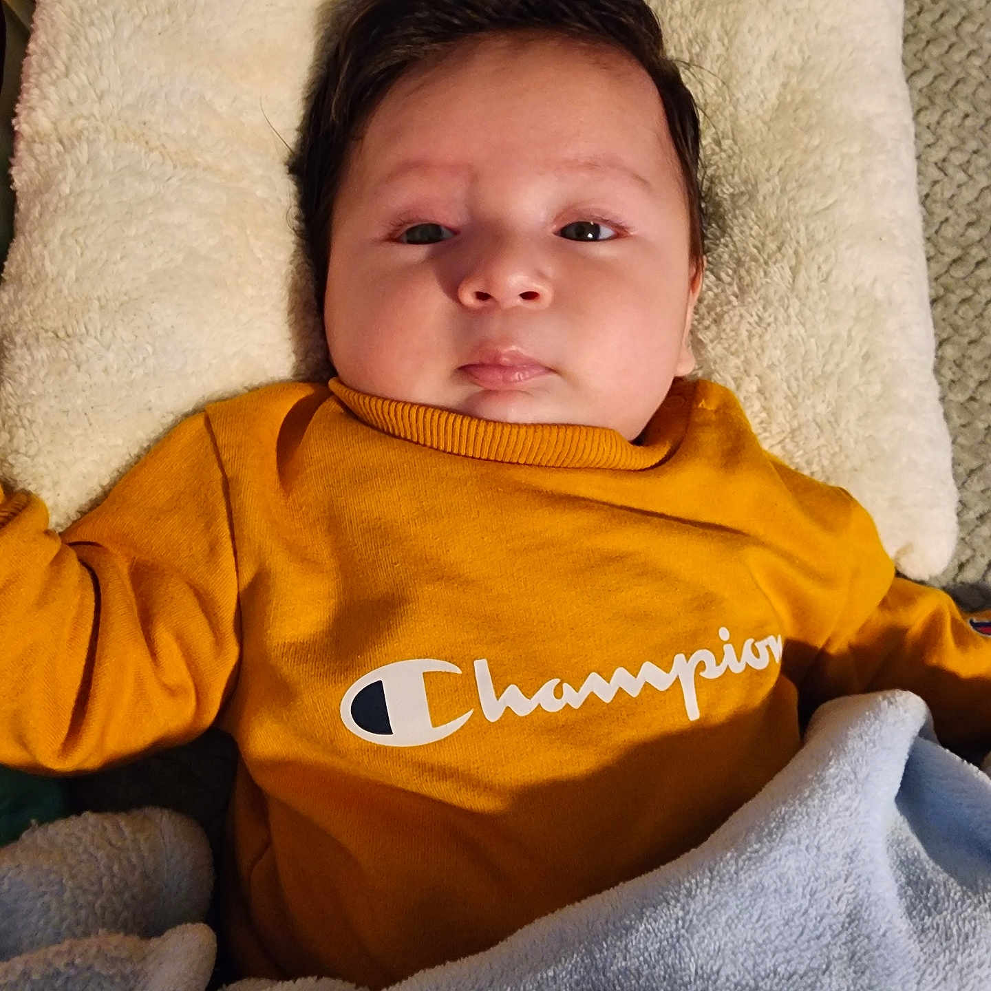 Uriel Navarro joined the competition — help win amazing prizes! baby, blanket, blue, child, clothing, cozy, cute, expression, face, indoors, infant, lying_down, person, pillow, portrait, soft, sweatshirt, warm, yellow, young