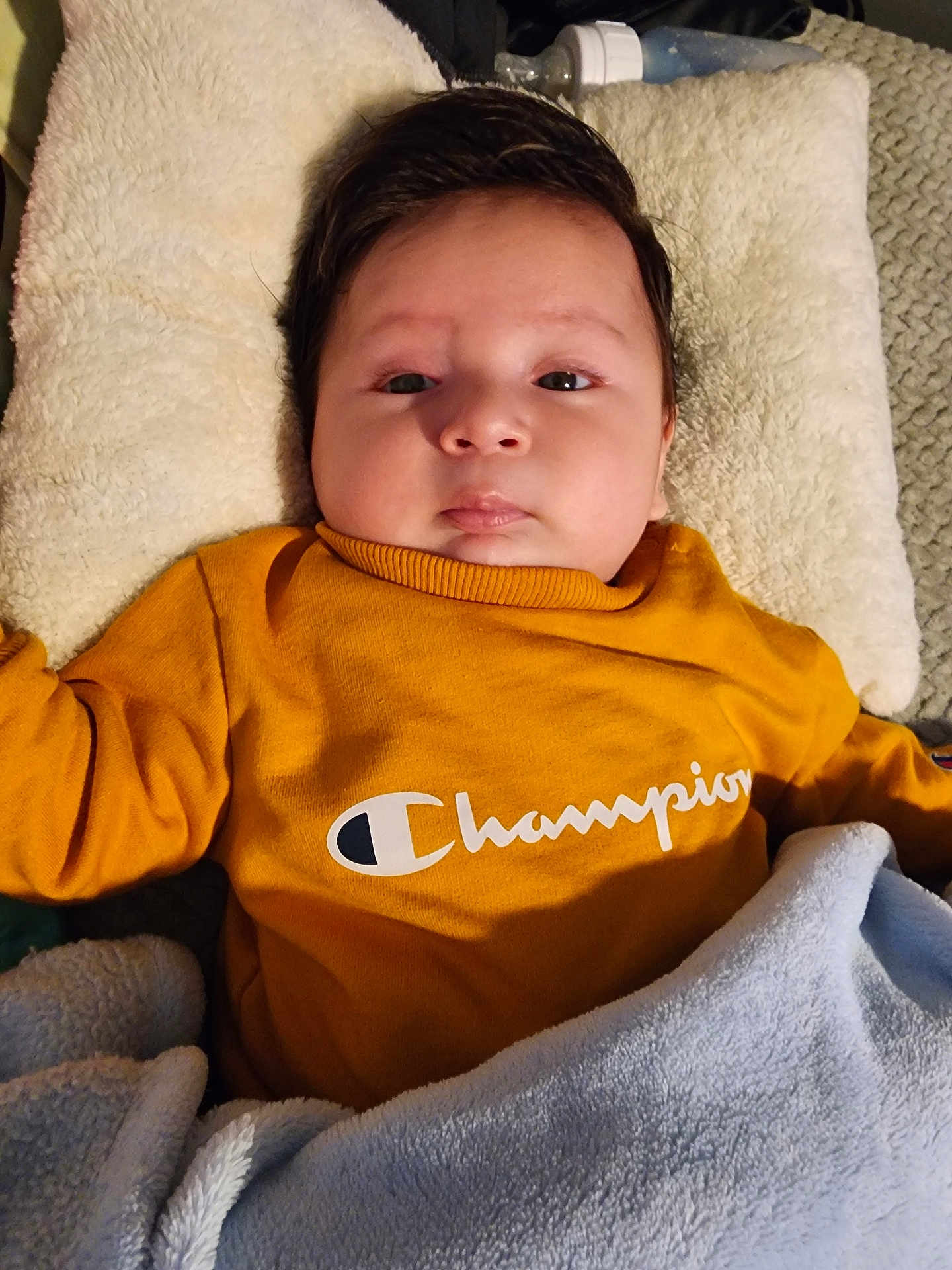 Uriel Navarro joined the competition — help win amazing prizes! baby, infant, child, blanket, clothing, pillow, face, person, portrait, sweatshirt, yellow, blue, soft, indoors, cute, lying_down, cozy, warm, expression, young