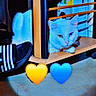 animal, blue_eye, blue_heart, box, cardboard, cat, floor, furniture, heart_emoji, heterochromia, indoors, light, pet, shadow, shoe, striped_shoe, white_cat, wood, yellow_eye, yellow_heart