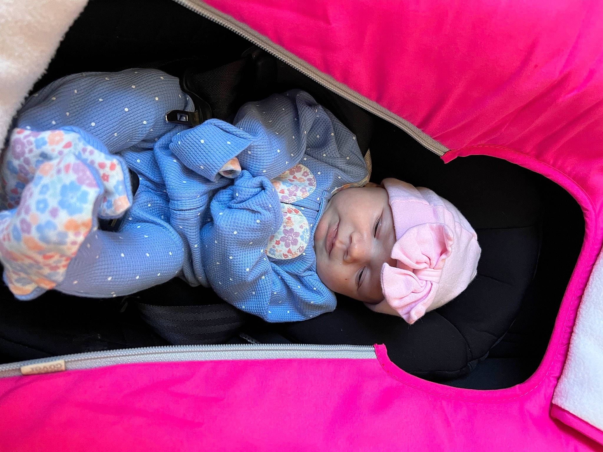 Raelynn is registered to the contest to win money with this photo: baby, baby_products, baby_toddler_clothing, car_seat, carmine, child, comfort, electric_blue, fun, headwear, linens, magenta, nap, person, pink, plastic_bag, room, sitting, sleep, textile