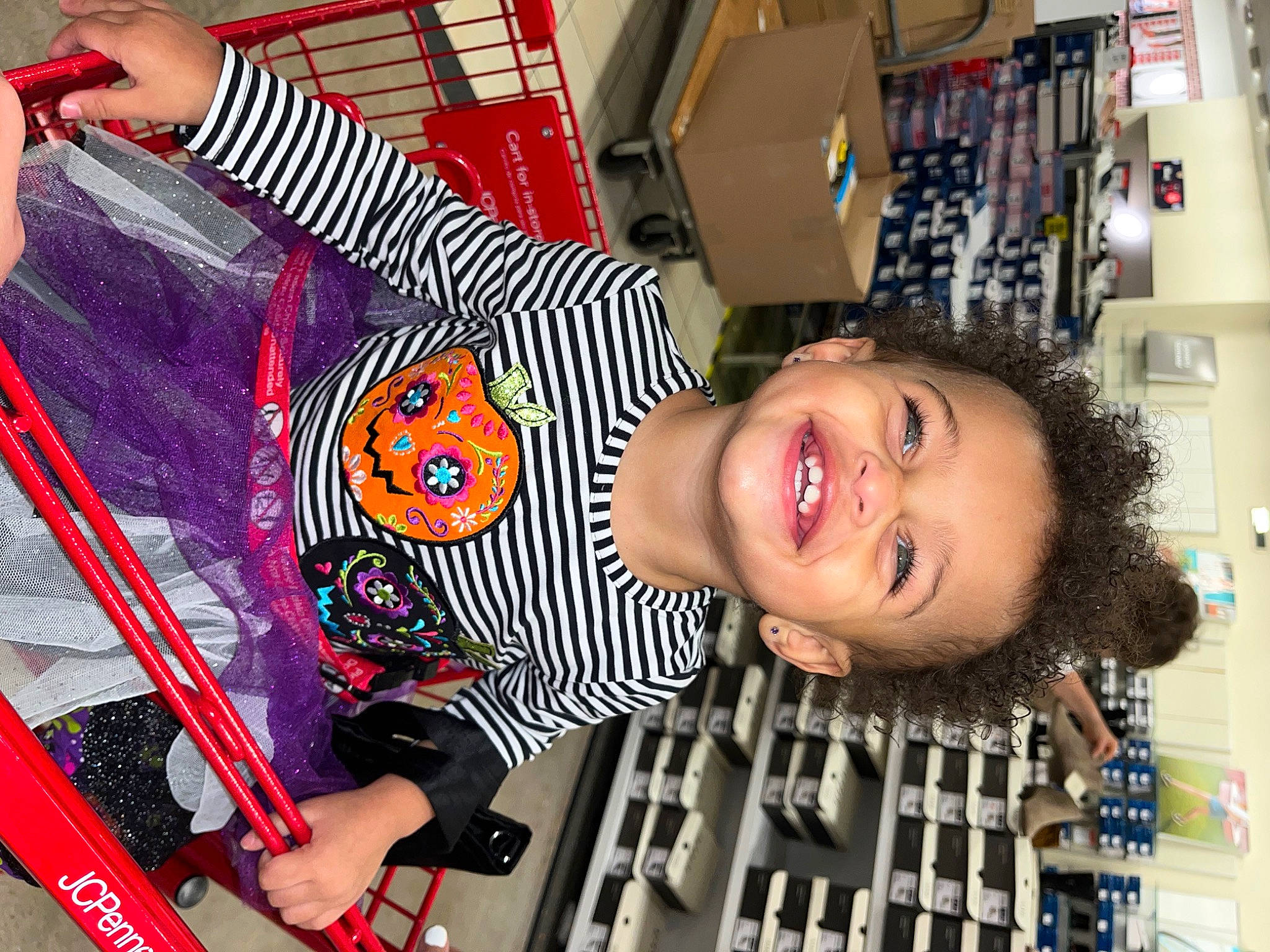 Camille is registered to the contest to win money with this photo: building, child, fun, happy, joy, leisure, magenta, pattern, person, photograph, room, shelf, smile, snapshot, t_shirt, toddler, toy, vacation