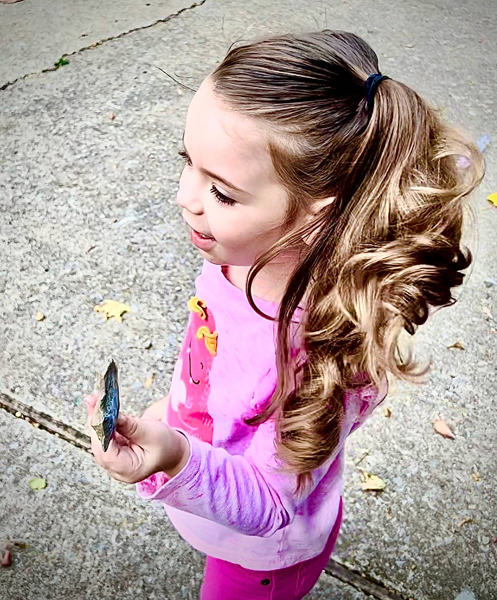 Story is registered to the contest to win money with this photo: beauty, blond, brown_hair, child, cool, fashion_accessory, fun, grass, hairstyle, hand, happy, iris, lip, long_hair, magenta, person, pink, road_surface, skin, soil