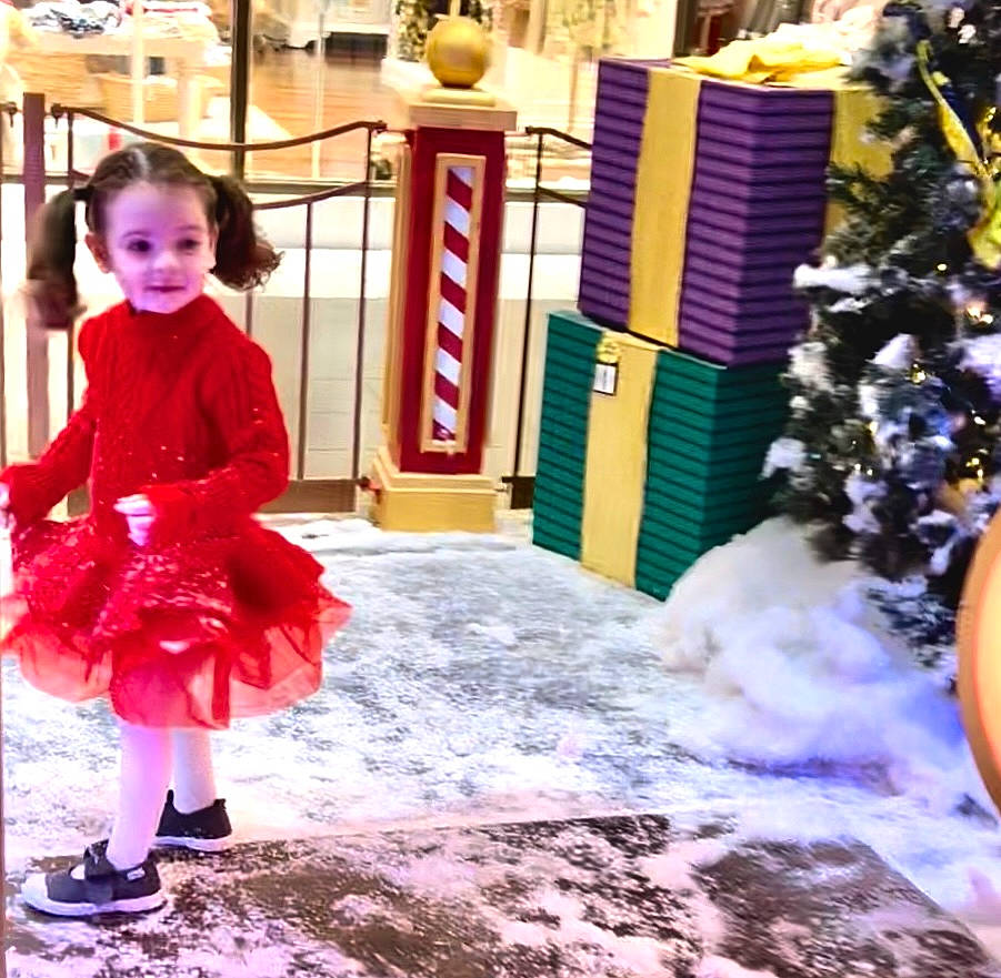 Story is registered to the contest to win money with this photo: baby_toddler_clothing, child, christmas_decoration, christmas_tree, city, conifer, door, event, flooring, fun, happy, leisure, magenta, person, play, public_space, purple, toddler, tradition, tree