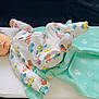 Parth joined the competition — help win amazing prizes! baby, infant, onesie, car_pattern, blanket, pillow, couch, furniture, child, cute, lying_down, indoor, soft_toys, colorful, face, head, skin, hair, clothing, relaxing