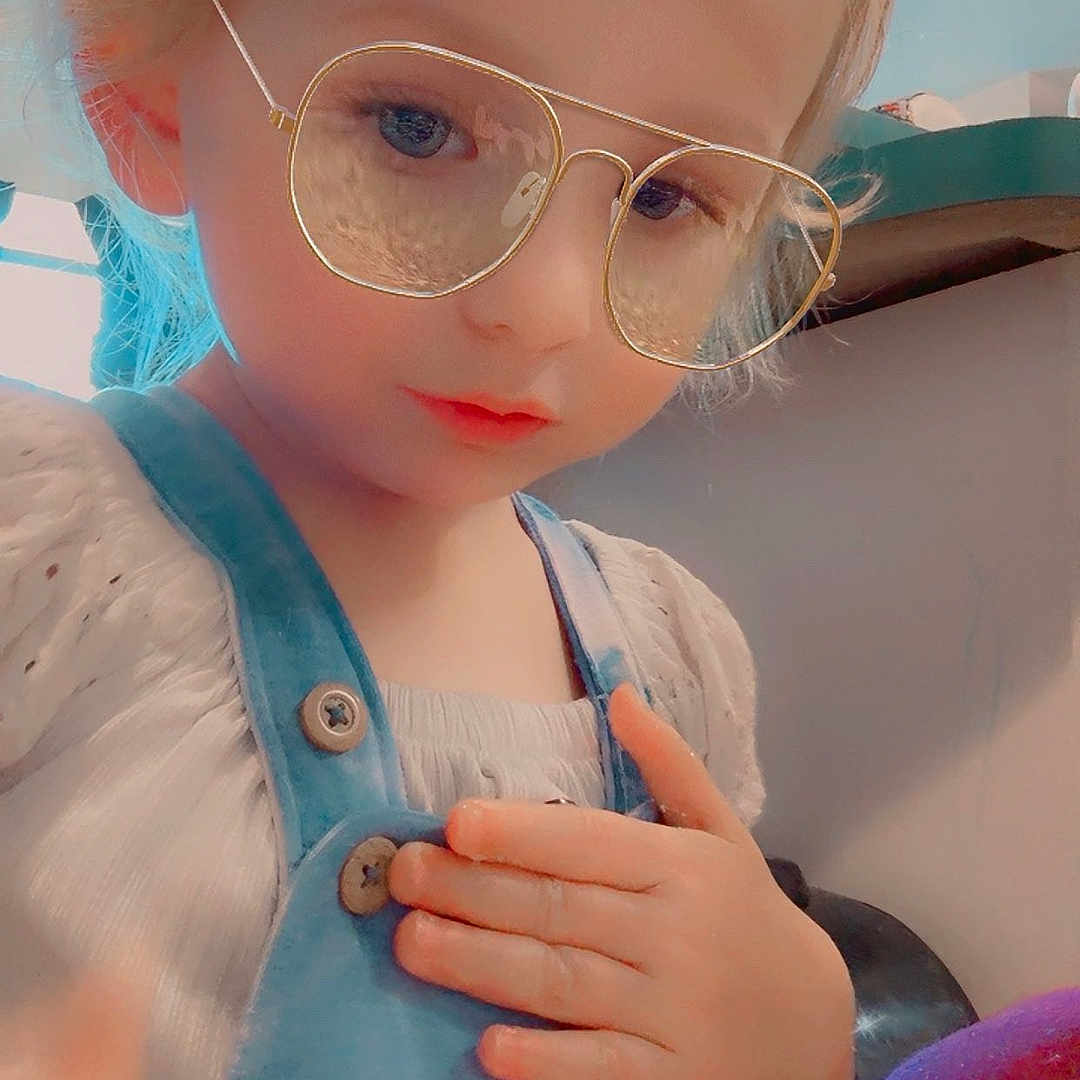 Kailiagh is registered to the contest to win money with this photo: blonde_hair, blurred_background, button, casual_clothing, child, closeup, cute, eyewear, face, glasses, hand, indoor, overalls, person, portrait, skin, soft_lighting, thoughtful, white_shirt, young_child