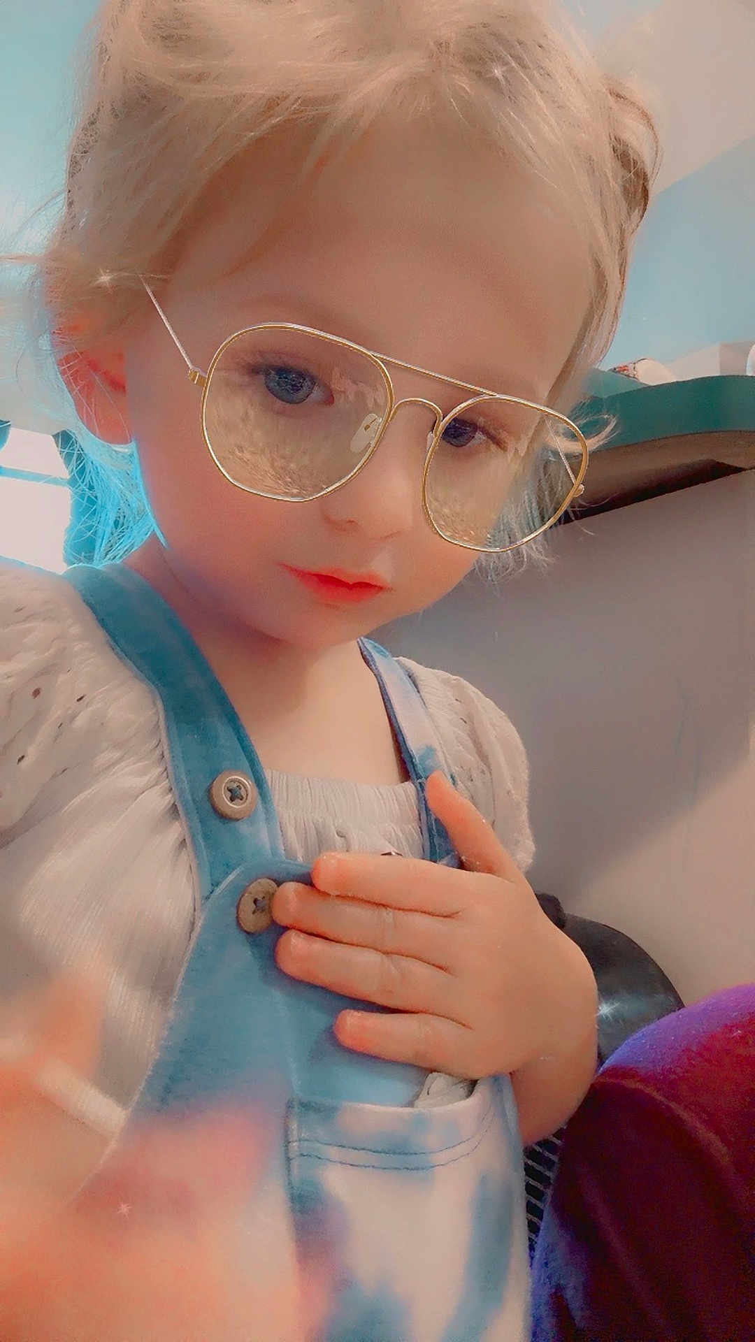 Kailiagh is registered to the contest to win money with this photo: blonde_hair, blurred_background, button, casual_clothing, child, closeup, cute, eyewear, face, glasses, hand, indoor, overalls, person, portrait, skin, soft_lighting, thoughtful, white_shirt, young_child