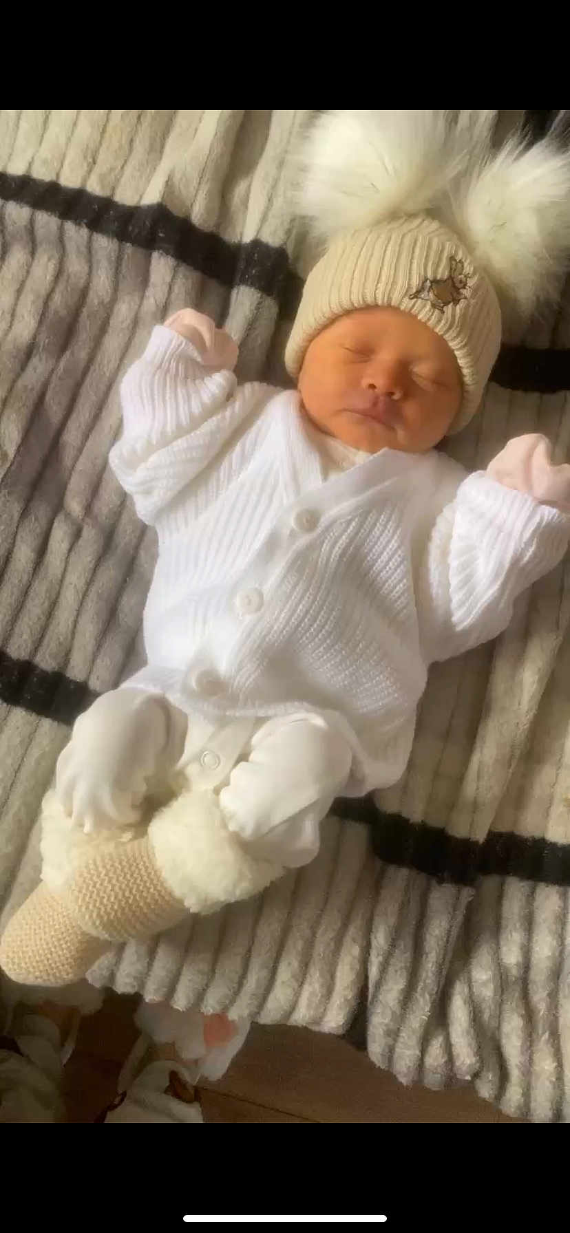 Harlow-Grace is registered to the contest to win money with this photo: baby, newborn, sleeping, white_clothing, knit_hat, pom_poms, blanket, soft_texture, booties, cozy, infant, cute, indoors, warm, resting, child, portrait, peaceful, small_hands, tiny_feet