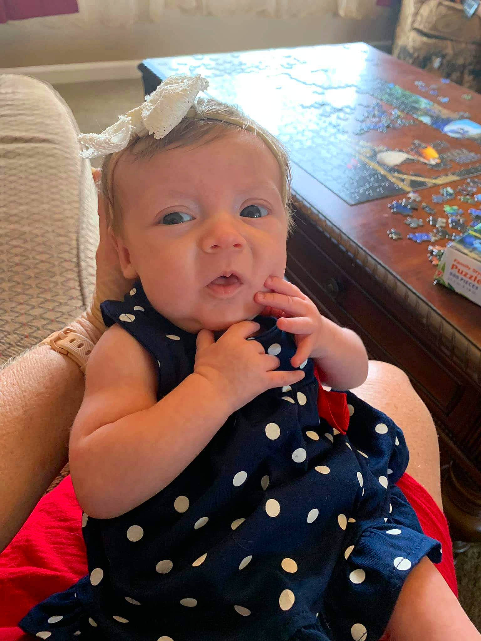 Giavanna is registered to the contest to win money with this photo: arm, baby, cheek, child, design, eye, finger, head, iris, nail, neck, pattern, person, polka_dot, thumb, toddler