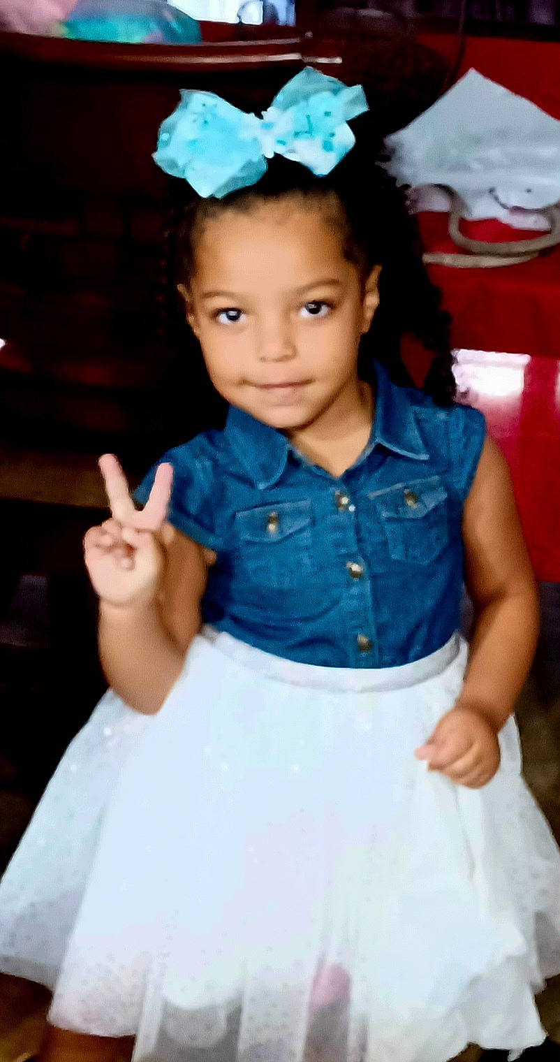 Nylah joined the competition — help win amazing prizes! black_hair, blue, child, clothing, dress, electric_blue, eye, fashion_design, flash_photography, fun, gesture, hairstyle, happy, iris, joy, person, pink, skin, sleeve, standing