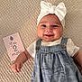 age_card, baby, blanket, blue_clothing, bow, card, child, closeup, cute, happy, headband, indoors, infant, lying_down, person, portrait, romper, smiling, soft_texture, white_shirt