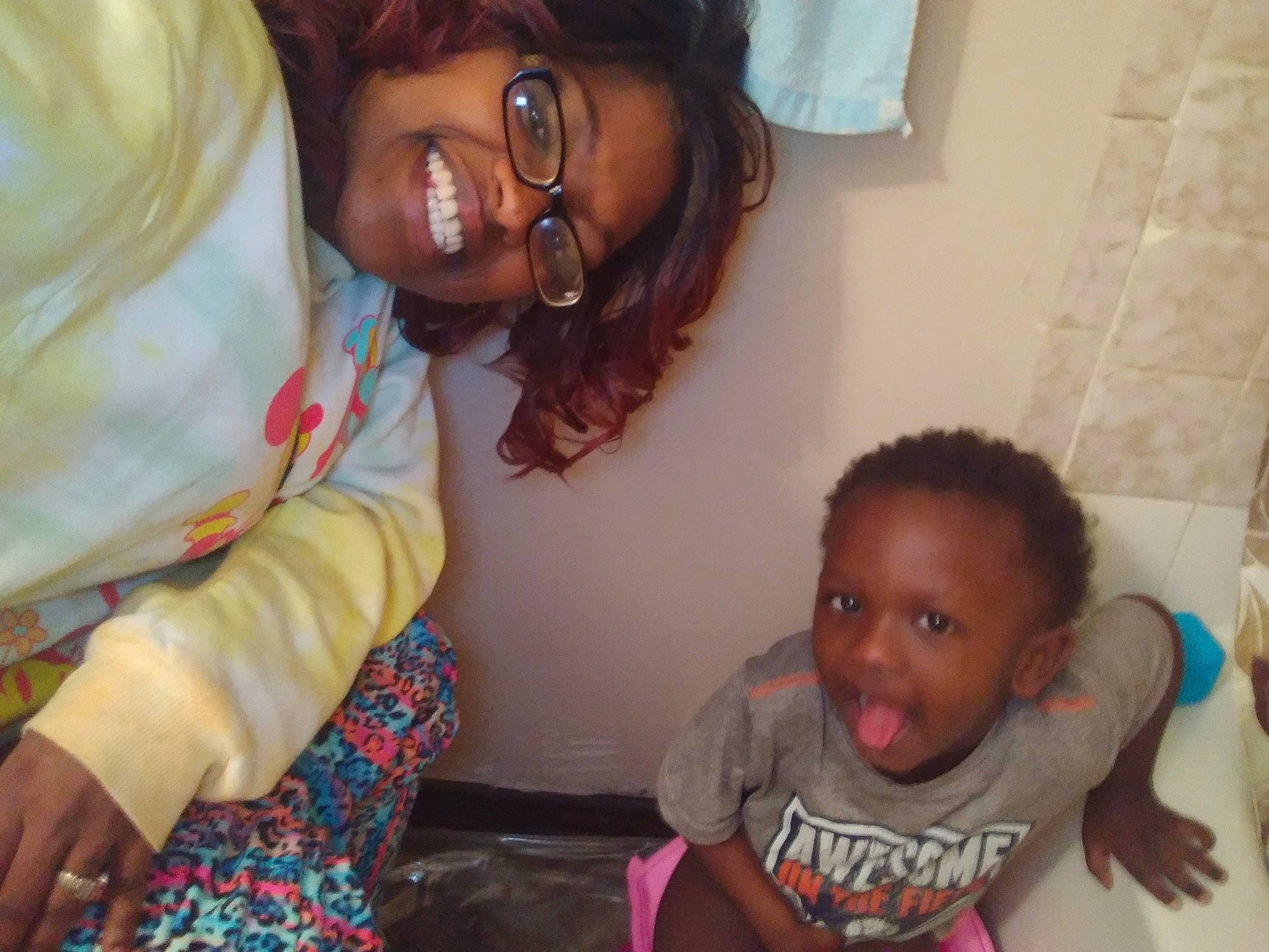 Jessiah is registered to the contest to win money with this photo: adaptation, baby, black_hair, cheek, child, electronic_device, fun, glasses, happy, mouth, nose, people, person, room, skin, smile, toddler