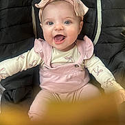 Paisley joined the competition — help win amazing prizes! baby, infant, smiling, headband, bow, pink_outfit, overalls, onesie, padded_seat, quilted_seat, wide_eyes, chubby_cheeks, open_mouth, tongue, portrait, cute, happy, indoors, soft_lighting, close_up