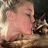 woman, cat, siamese_cat, kiss, affection, close_up, portrait, pet, animal, human, love, face, skin, fur, earring, necklace, indoor, intimacy, expression, warmth