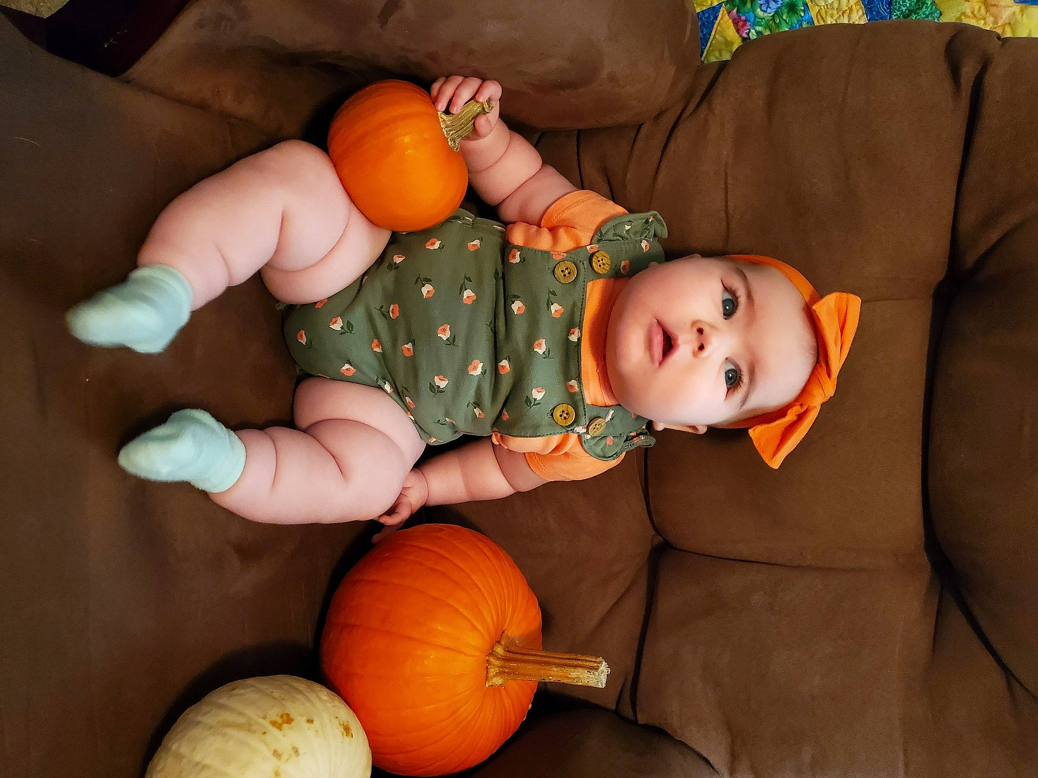 Lilyanne is registered to the contest to win money with this photo: baby, baby_toddler_clothing, calabaza, child, comfort, cucurbita, eye, facial_expression, gourd, head, headwear, human_body, natural_foods, orange, person, plant, pumpkin, squash, toddler, vegetable