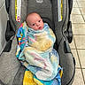 baby, infant, car_seat, britax, towel, wrapped, indoor, tile_floor, tile_wall, seat, child, person, young, cute, blanket, colorful, looking, sitting, portrait, comfort