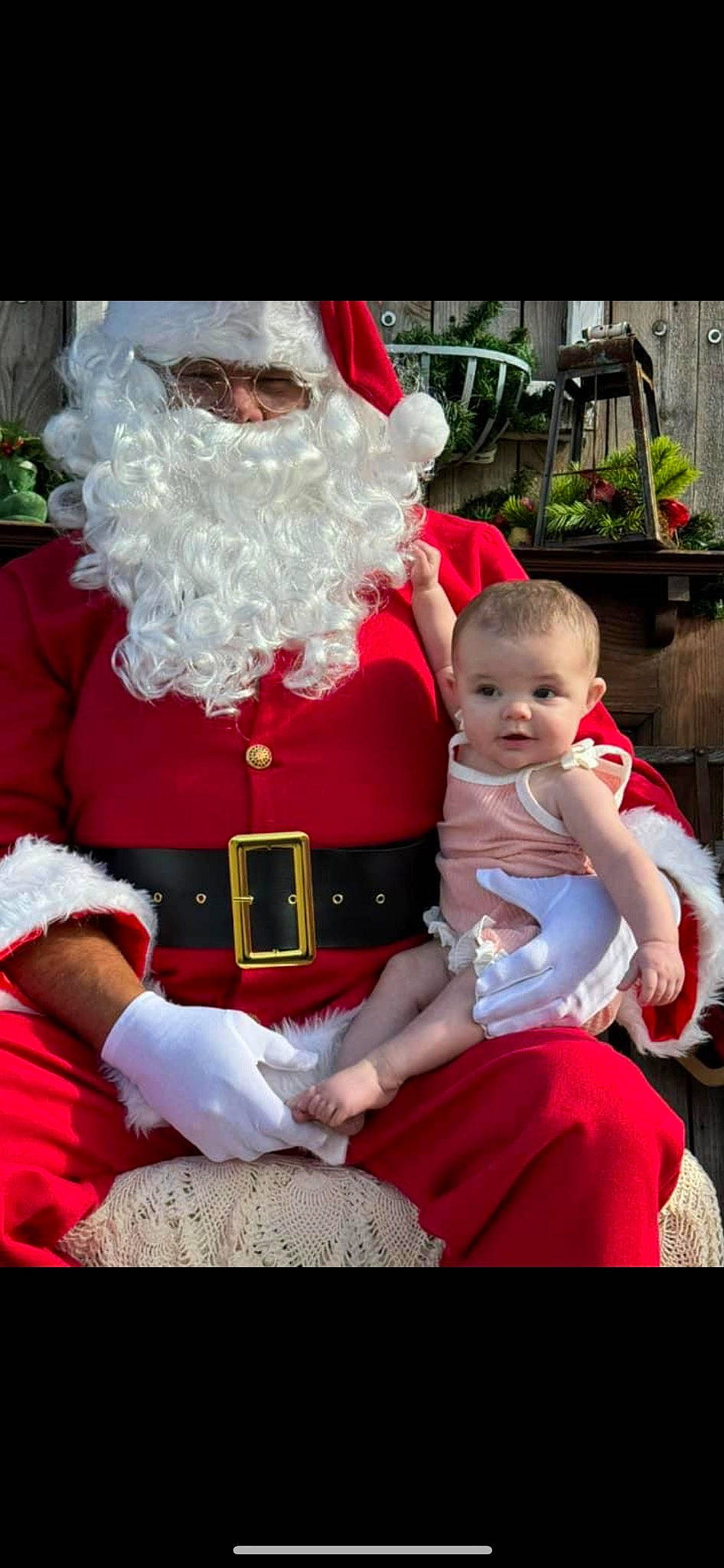 Raelynn is registered to the contest to win money with this photo: baby, beard, child, christmas, christmas_eve, costume_hat, event, facial_hair, fictional_character, happy, hat, holiday, human_body, lap, person, plant, santa_claus, sitting, toddler, tradition
