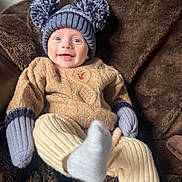 Ezra joined the competition — help win amazing prizes! baby, smiling, hat, knitwear, mittens, pants, blanket, cozy, cute, child, happy, apparel, warm, indoor, portrait, face, wool, sitting, infant, soft