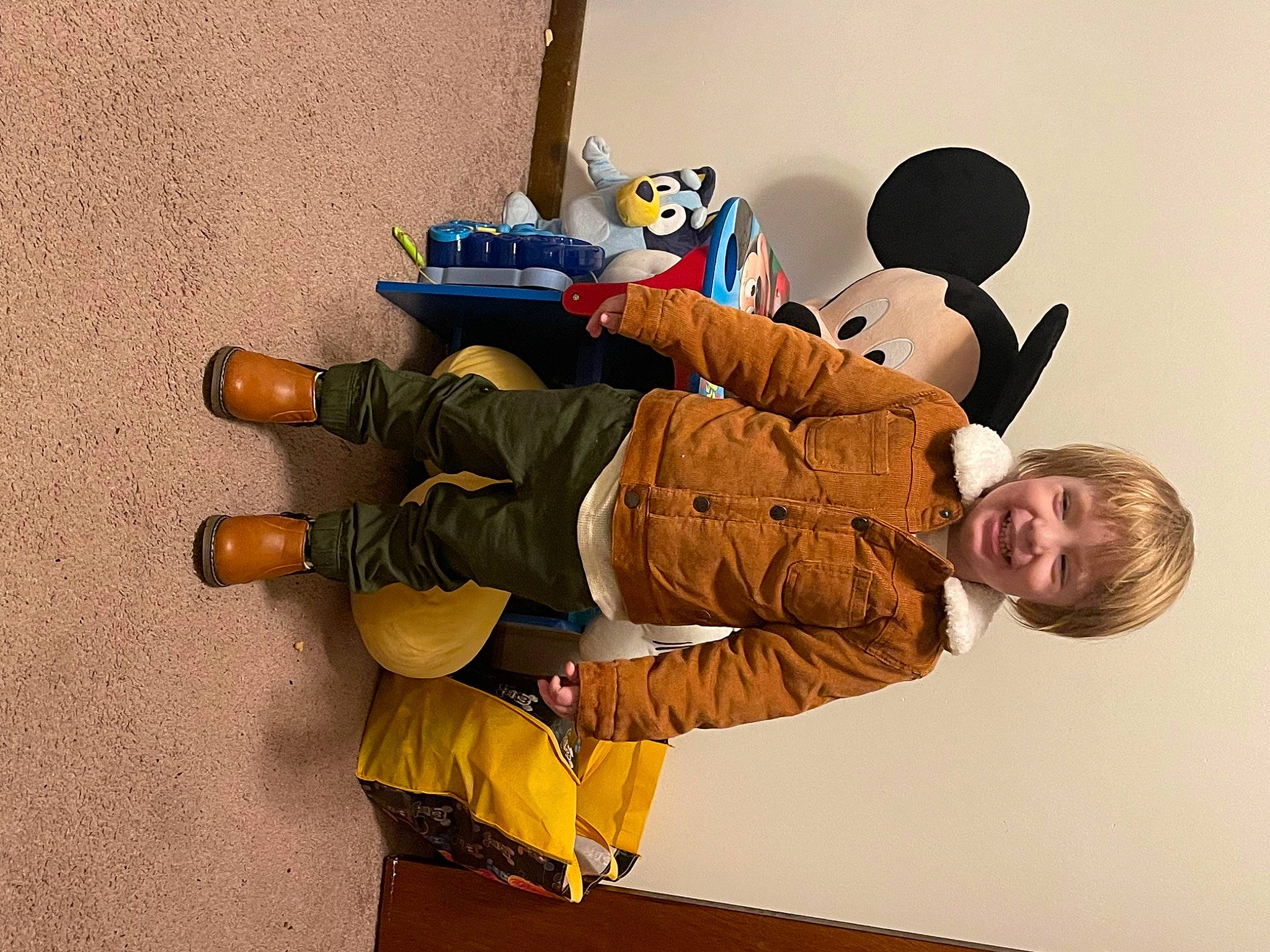 Adam is registered to the contest to win money with this photo: baby, baby_toddler_clothing, child, comfort, flooring, fun, happy, joy, khaki_pants, knee, outdoor_shoe, person, room, sitting, sleeve, toddler, walking_shoe, wood