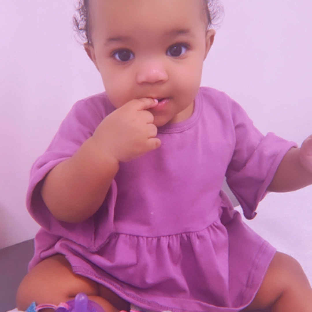 Lamani joined the competition — help win amazing prizes! adorable, baby, bows, child, curly_hair, cute, finger_in_mouth, girl, indoor, infant, innocence, pacifier, playful, plush_toy, portrait, purple_dress, sitting, soft_surface, toddler, young_child