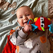 Alessio a rejoint le concours — aidez-le/la à gagner de superbes lots ! baby, smiling, toy, blanket, bear_design, halloween_sweater, ghost, pumpkin, bat, baby_clothing, infant, child, cute, happy, indoor, colorful, playful, portrait, closeup, person