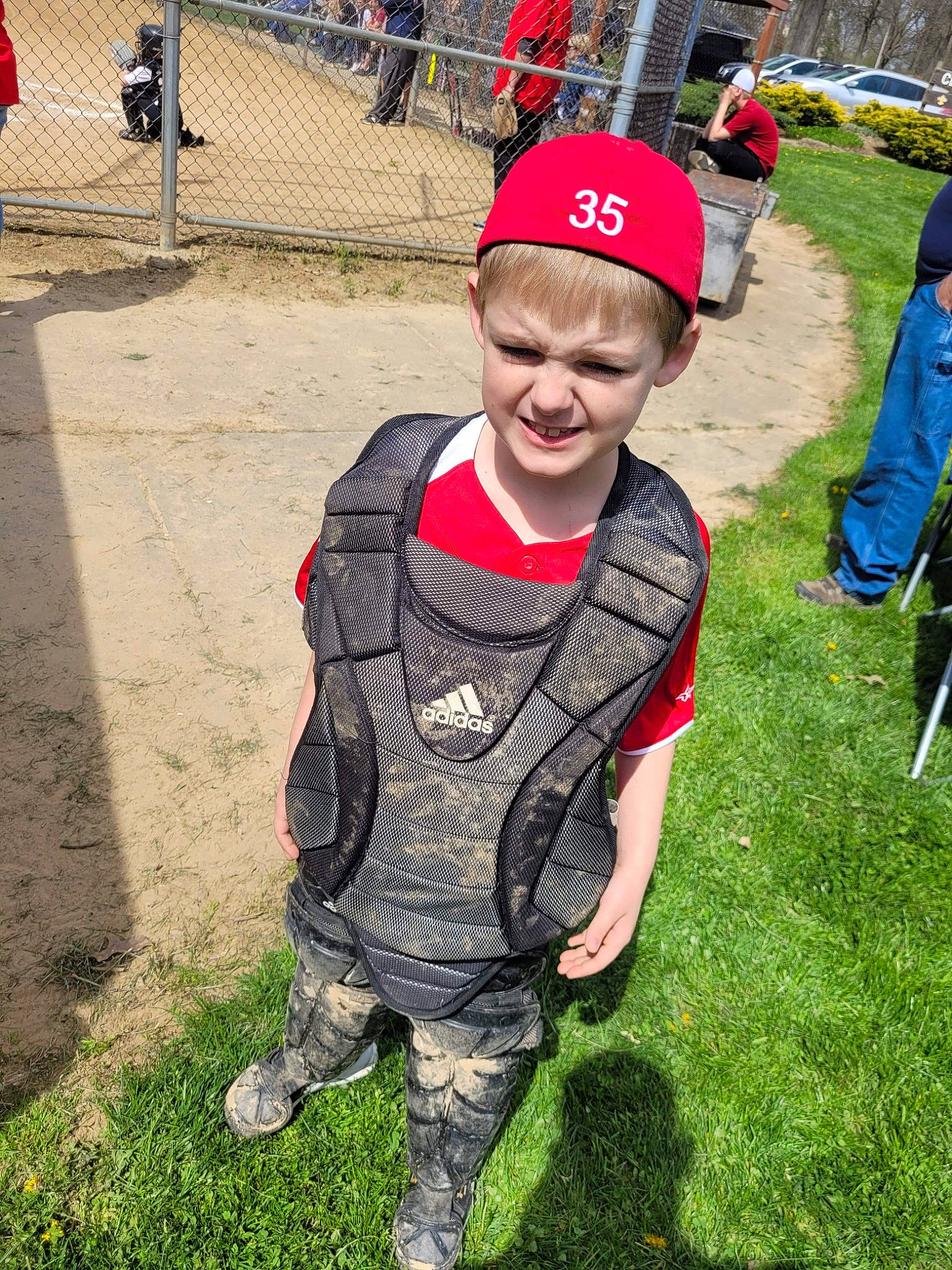 Hunter is registered to the contest to win money with this photo: baseball_cap, cap, chair, child, fun, grass, happy, joy, leisure, pattern, person, personal_protective_equipment, plant, play, recreation, sleeve, soil, t_shirt, toddler, tree