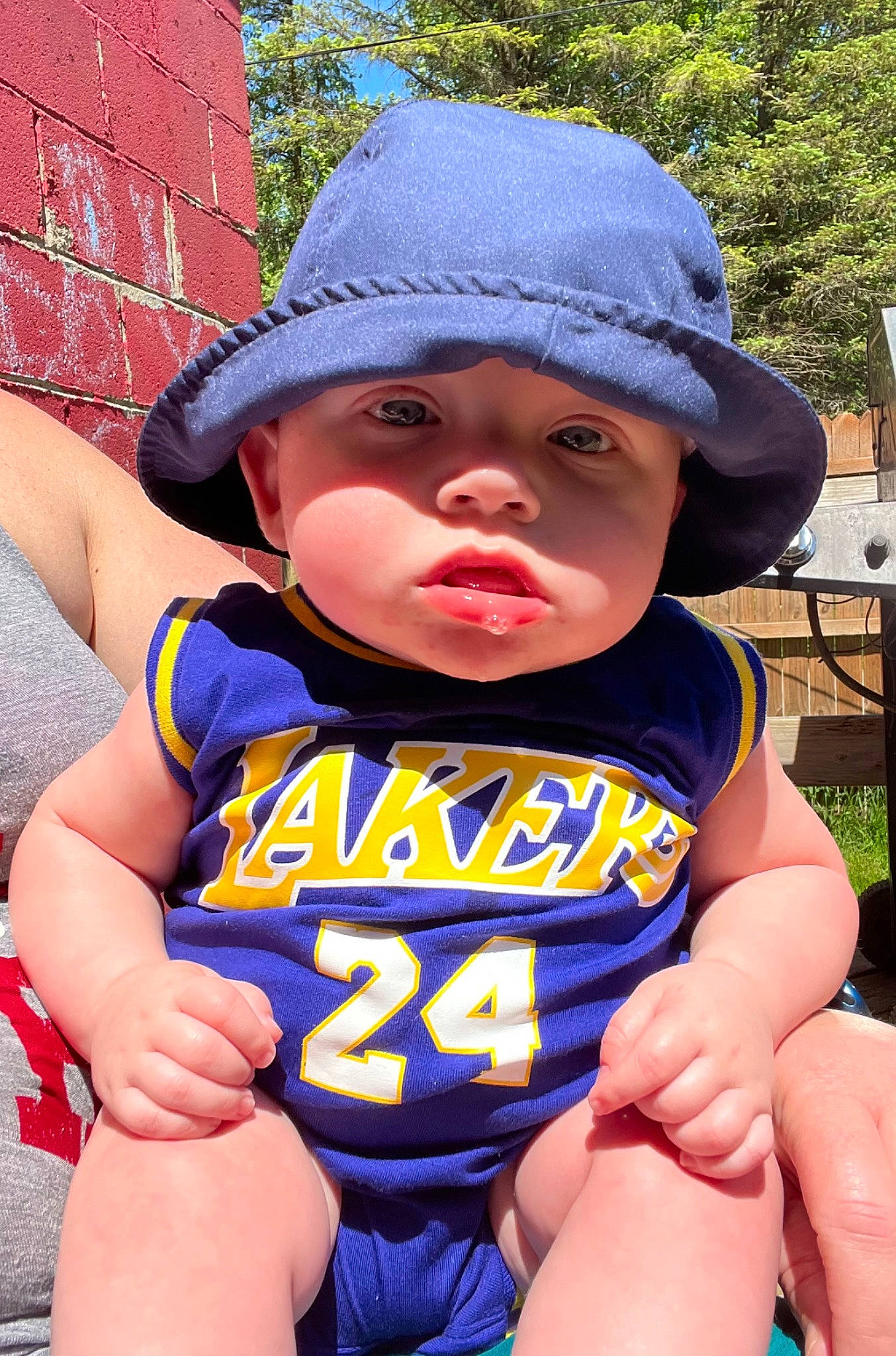 Payton is registered to the contest to win money with this photo: baby, baby_toddler_clothing, cap, child, cool, electric_blue, fun, grass, hand, happy, hat, headgear, headwear, leisure, lip, person, personal_protective_equipment, summer, sun_hat, thigh