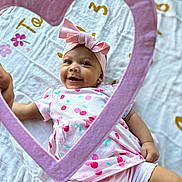 Amelia joined the competition — help win amazing prizes! baby, infant, smiling, pink_bow, heart_frame, blanket, cute, child, patterned_clothing, happy, lying_down, headband, cherry_pattern, soft_texture, indoors, playful, bright, portrait, adorable, toddler