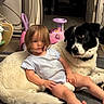 Elliana joined the competition — help win amazing prizes! toddler, child, dog, indoor, toy, pink_toy, floor, carpet, pet, animal, person, hair, clothing, white_dog, black_dog, flooring, furniture, relaxing, cute, home