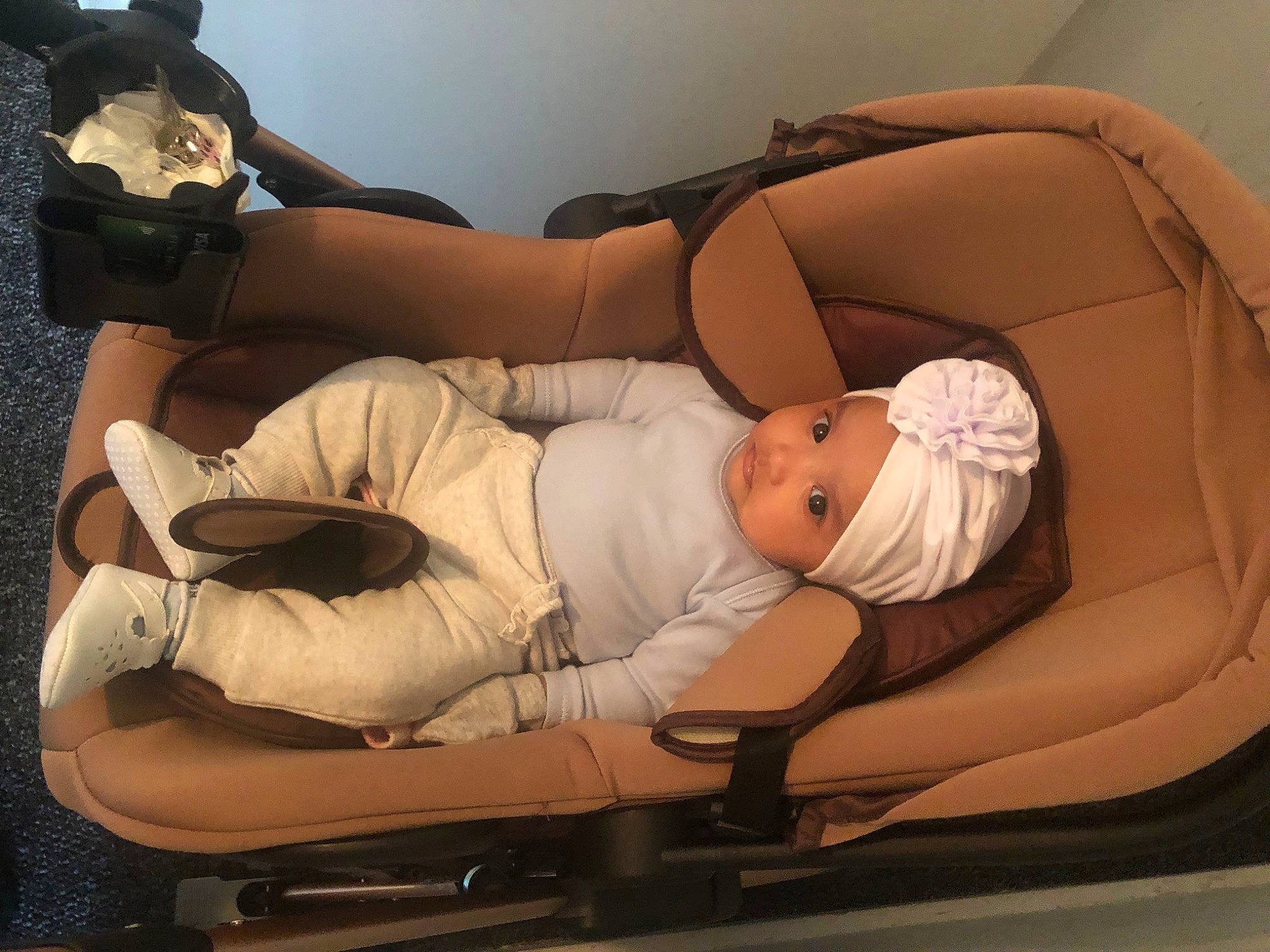 Aisha is registered to the contest to win money with this photo: abdomen, baby, baby_products, child, comfort, elbow, finger, foot, headwear, health_care, human_leg, knee, lap, medical, medical_equipment, nap, person, room, service, sitting