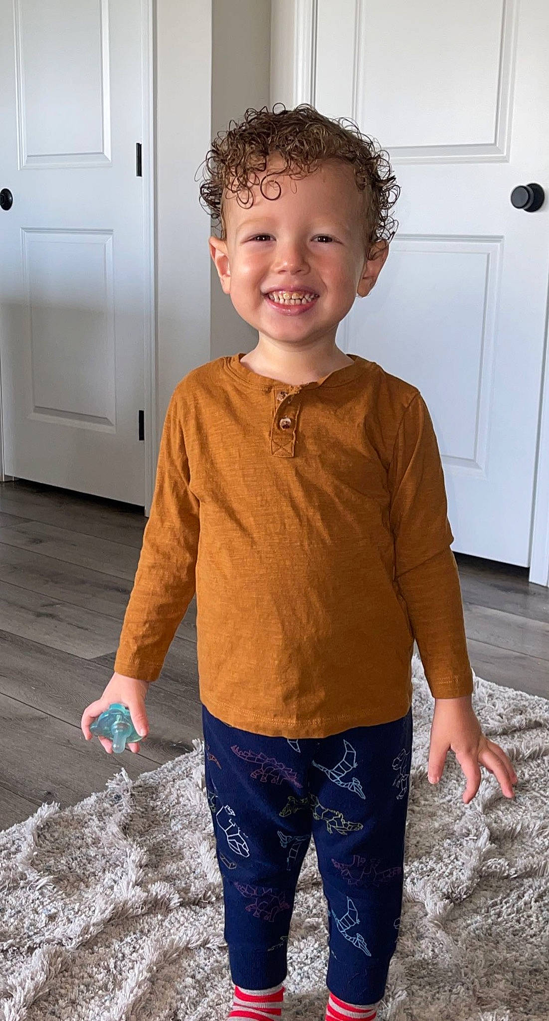 Zain is registered to the contest to win money with this photo: blue, chin, cool, door, eye, floor, flooring, happy, joint, joy, neck, organ, people, person, shoulder, sleeve, smile, standing, t_shirt, toddler