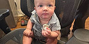 Colton joined the competition — help win amazing prizes! baby, blue_eyes, cabinet, child, clothing, curious, cute, expression, floor, foot, furniture, hand, human, indoor, mesh_chair, object, office_chair, person, shirt, sitting