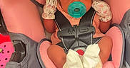 Khazaria is registered to the contest to win money with this photo: baby, infant, car_seat, pacifier, mittens, pink, gray, clothing, person, child, seatbelt, footwear, socks, indoor, cute, young, newborn, face, head, sitting