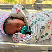Khazaria joined the competition — help win amazing prizes! newborn, baby, sleeping, pacifier, hospital, bassinet, blanket, hat, infant, swaddled, footprint_pattern, striped_hat, resting, indoor, soft_light, cute, peaceful, child, person, closeup