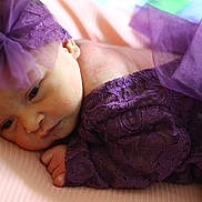 Ivy is registered to the contest to win money with this photo: baby, newborn, infant, purple_lace, headband, sleeping, soft, closeup, portrait, cute, delicate, resting, pink_background, child, small_hand, peaceful, fabric, texture, face, skin