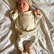 Amalya participe au concours pour gagner de l'argent avec cette photo : baby, bed, blanket, clothing, cozy, cute, furniture, headwear, indoors, infant, leggings, newborn, pattern, person, portrait, resting, sleepwear, slippers, soft_toys, turban