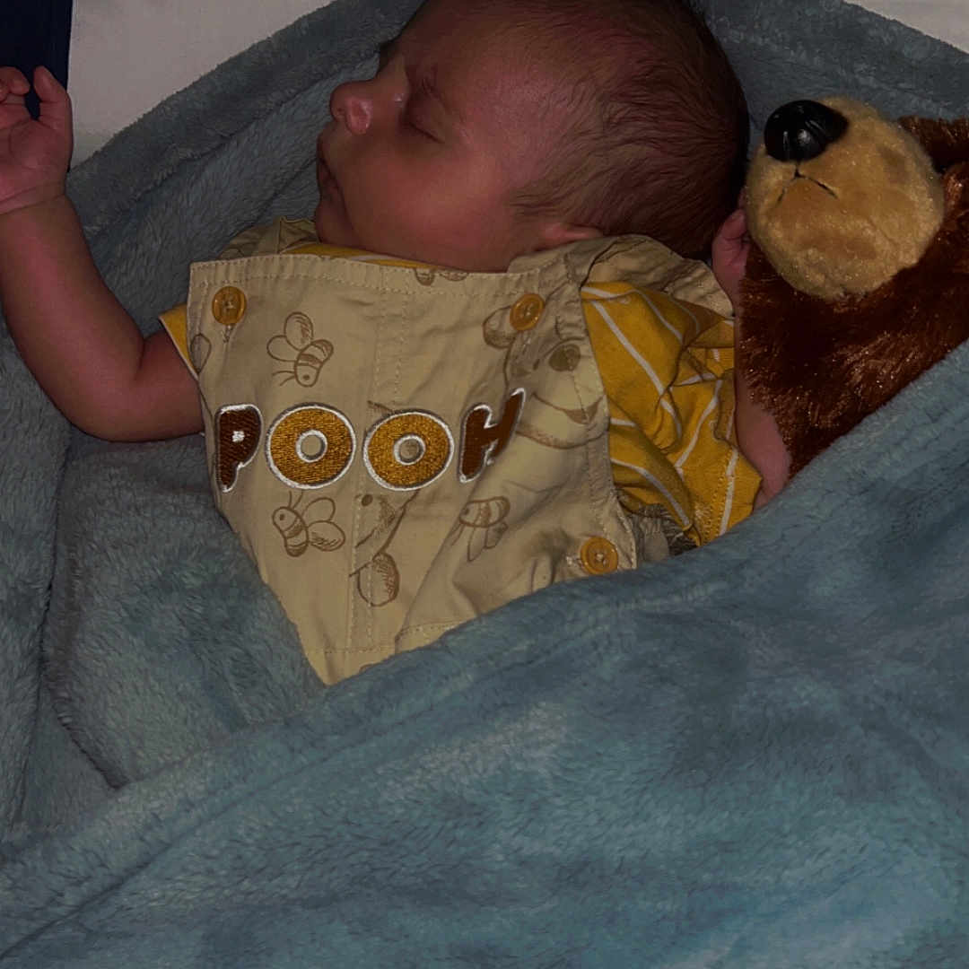 Cyrus Rhain is registered to the contest to win money with this photo: adorable, baby, blanket, child, clothing, comfort, cozy, cute, indoor, infant, nap, peaceful, plush_toy, pooh, portrait, rest, sleeping, soft_texture, teddy_bear, yellow