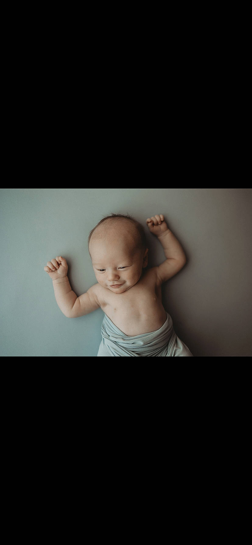 Cameron is registered to the contest to win money with this photo: abdomen, baby, cheek, chest, child, darkness, ear, elbow, flash_photography, fun, gesture, happy, human_body, jaw, neck, person, portrait_photography, room, sitting, stomach
