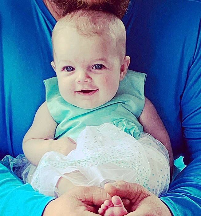 Calleigh is registered to the contest to win money with this photo: arm, azure, baby, baby_toddler_clothing, blue, cheek, comfort, facial_expression, finger, gesture, hairstyle, hand, happy, iris, mouth, neck, person, skin, sleeve, smile