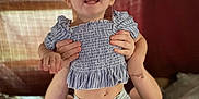 Aiyana is registered to the contest to win money with this photo: baby, blouse, bodypart, clothing, couch, cushion, face, finger, furniture, hand, happy, head, homedecor, indoors, pants, person, photography, portrait, shorts, smile