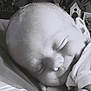 baby, sleeping, black_and_white, infant, close_up, peaceful, face, head, blanket, soft, cute, newborn, child, portrait, toddler, resting, indoor, clothing, calm, expression