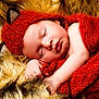 baby, sleeping, red_hat, knit_blanket, fur_blanket, infant, cute, cozy, soft_texture, newborn, peaceful, wrapped, face, hand, portrait, resting, warm_colors, adorable, child, sleep