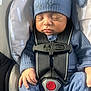 baby, infant, sleeping, car_seat, car_safety_harness, blue_clothing, hat, baby_hand, baby_face, child, newborn, seat_belt, infant_clothing, close_up, resting, cozy, transport, child_safety, peaceful, portrait