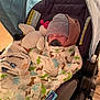 Quinn is registered to the contest to win money with this photo: baby, sleeping, blanket, dinosaur_pattern, hat, pacifier, stroller, plush_toy, bunny, cozy, child, infant, cute, resting, warm_clothing, indoors, comfort, soft_lighting, wrapped, peaceful