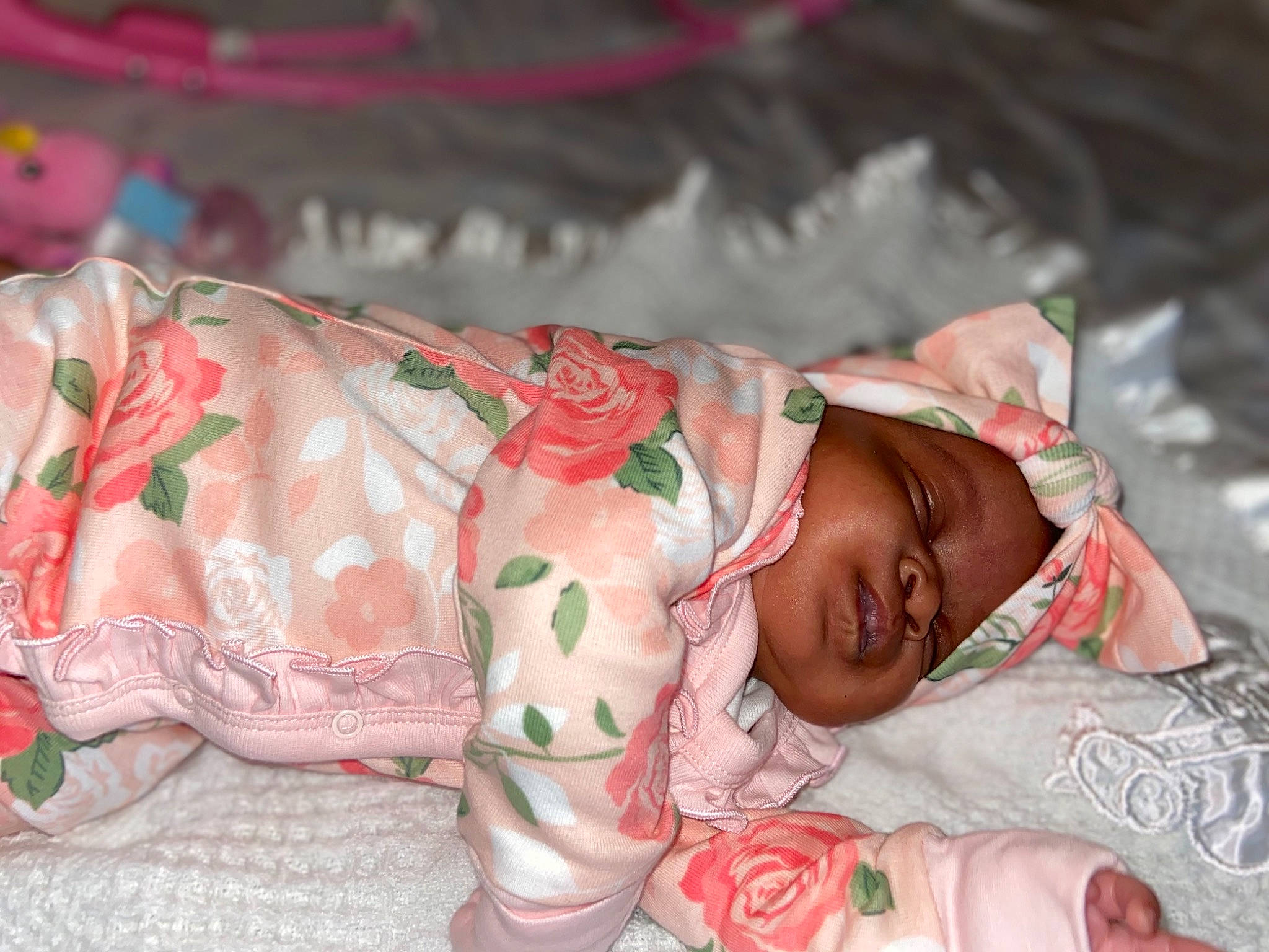 Nyema is registered to the contest to win money with this photo: abdomen, baby, baby_toddler_clothing, bedtime, carmine, cheek, child, comfort, event, flesh, hand, head, linens, pattern, person, pink, room, skin, sleeve, textile