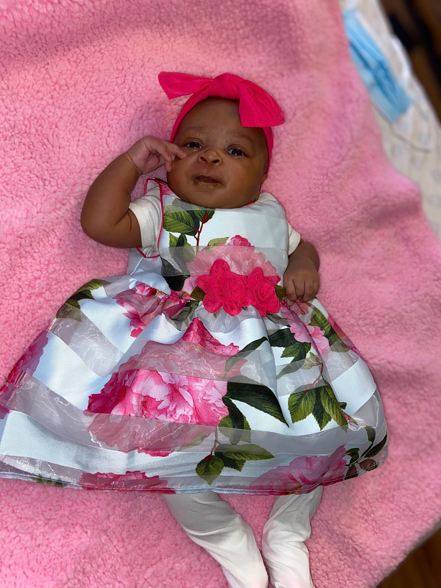 Nyema is registered to the contest to win money with this photo: baby, baby_products, baby_toddler_clothing, child, comfort, dress, event, happy, headwear, linens, magenta, pattern, person, petal, pink, product, purple, sleeve, smile, sun_hat