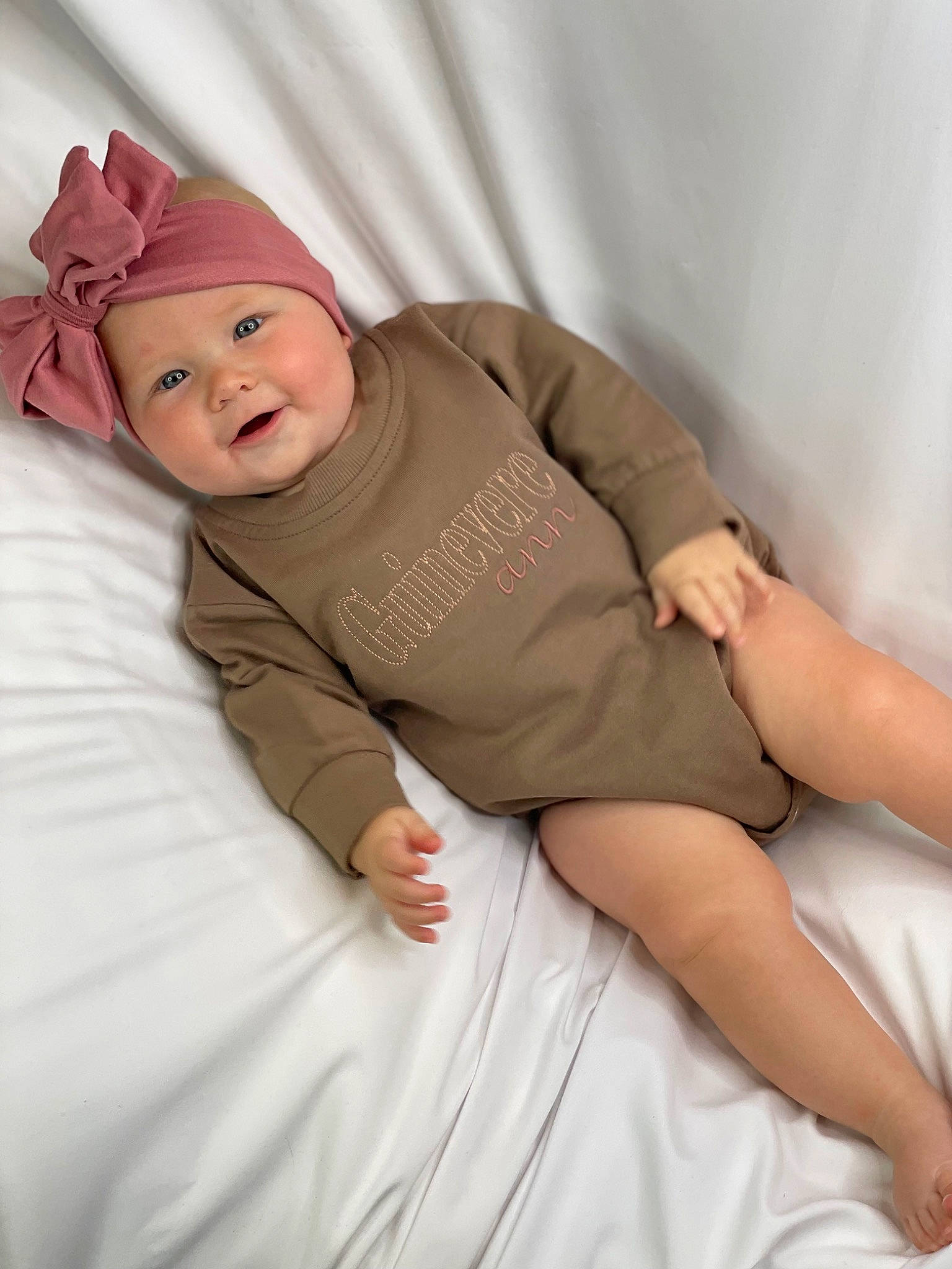 Guinevere joined the competition — help win amazing prizes! arm, baby, baby_toddler_clothing, bed, bed_sheet, bedding, child, comfort, hat, headwear, human_body, human_leg, joy, knee, linens, person, pink, room, sitting, skin