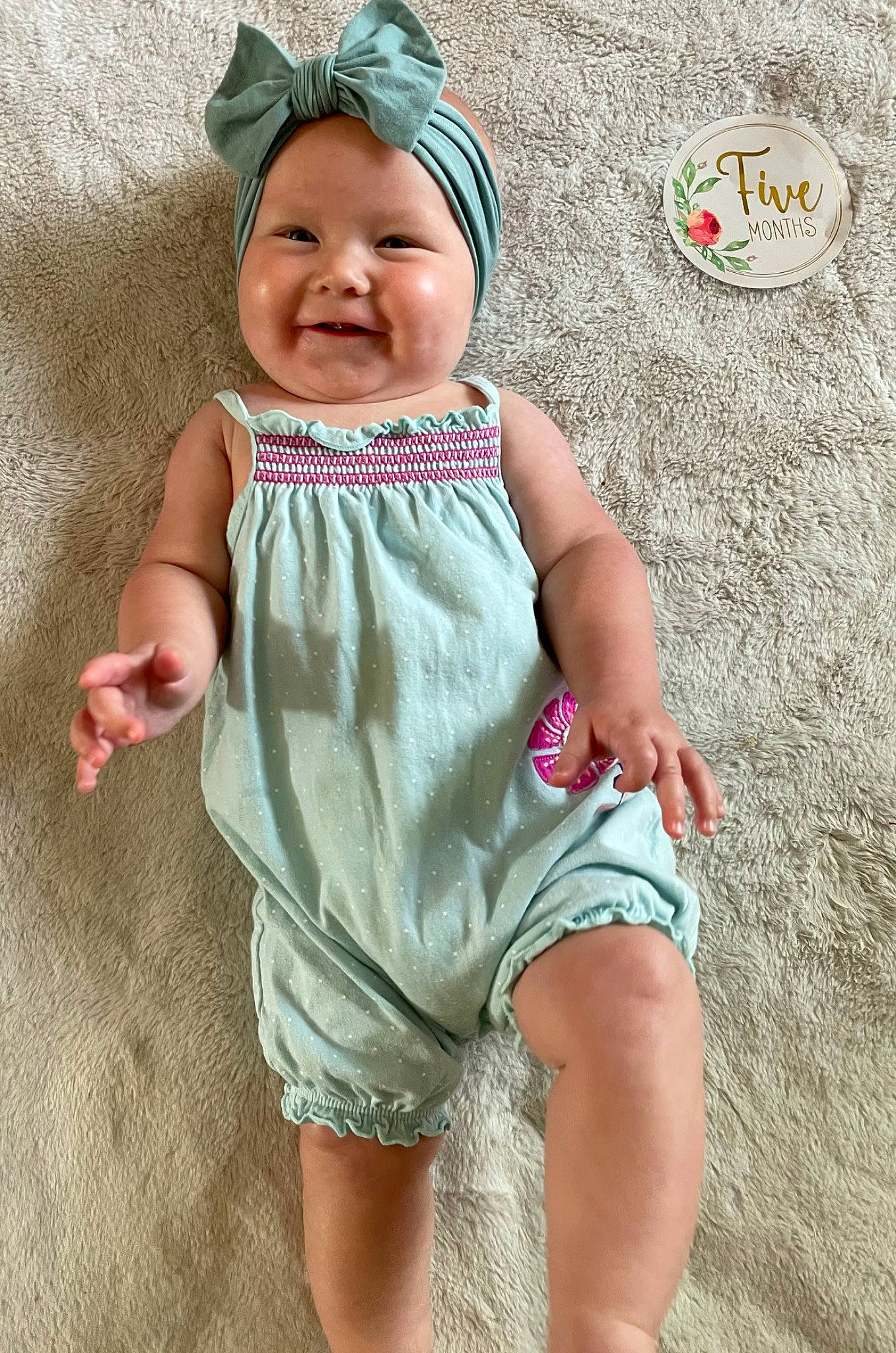 Guinevere is registered to the contest to win money with this photo: baby, baby_toddler_clothing, barefoot, cap, child, cool, face, fun, grass, happy, head, headwear, human_leg, joy, pattern, person, pink, skin, sleeve, smile